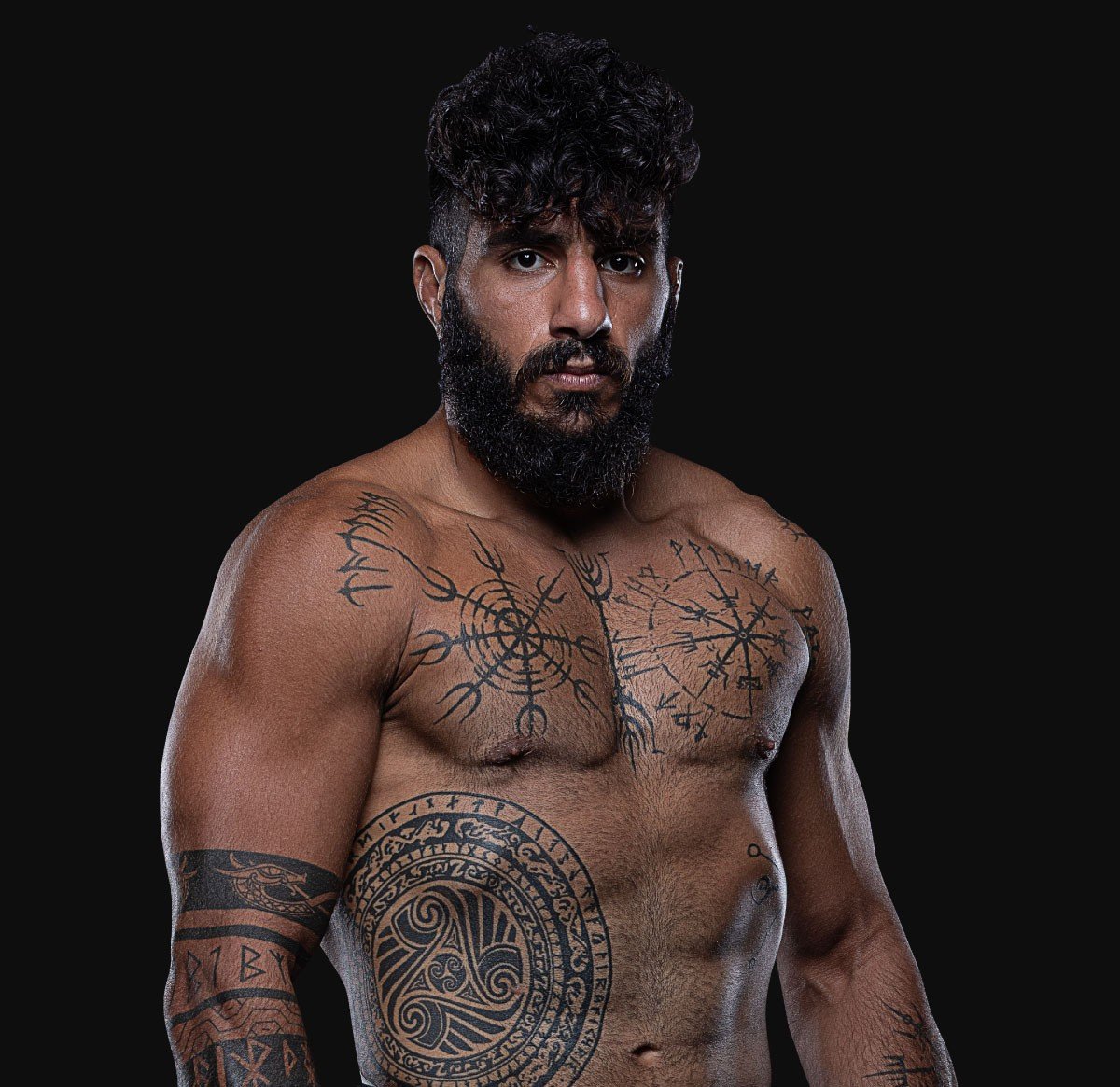 Official portrait of Namo Fazil showing his Norse vegvísir tattoos